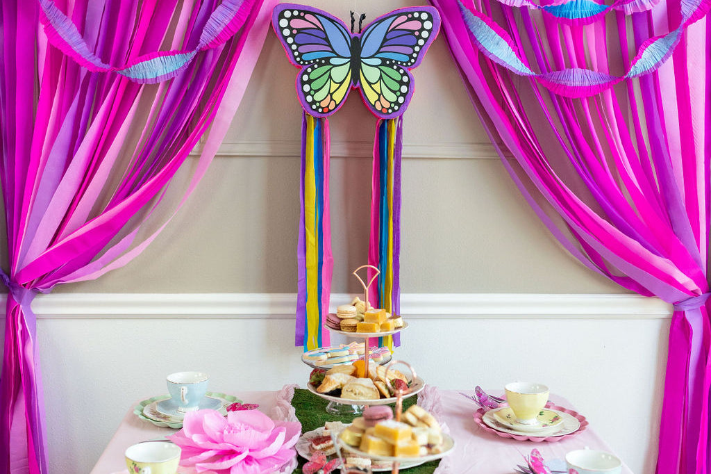 Riles & Bash Rainbow Butterfly Pinata with Colorful Streamers and Pink and Purple Streamer Backdrop_Butterfly Birthday_Rainbow Birthday